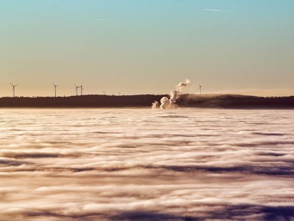 Three columns of steam rising from cloud cover