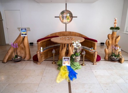 Picture with peace dove and flag of Ukraine on silk cloths in the Ukrainian national colours blue and yellow in the chancel of Germany's first private ecumenical motorway church Geiselwind Light on ou...