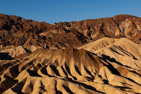 Coloured rock formations in the evening light at Zabriskie Point