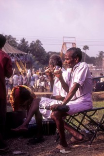 People having tea near an exhibition during Pooram festival in Thrissur or Trichur