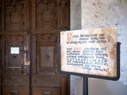 Sign in front of the portal of the Catholic parish church of St. George