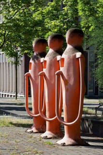 Three human petrol pumps refuelling themselves