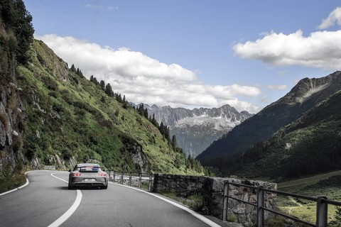Porsche 911 GT3 sports car on well-built Alpine road from Sustenpass to Wassen