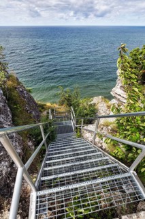 View from above of metal stairs and cliff Hoegklint in summer
