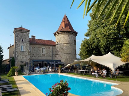 View over swimming pool to castle tower Tower of Chateau de Chapeau Cornu