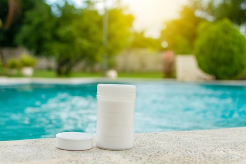 Chlorine tablets kit in the edge of a swimming pool