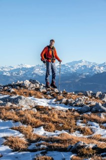 Mountaineer in front of mountain panorama