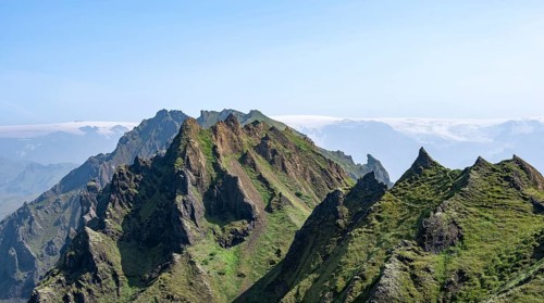 Pointed green mountain peaks on the ridge of Tindfjoell