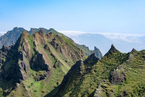 Pointed green mountain peaks on the ridge of Tindfjoell