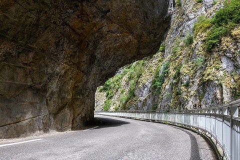 Far overhanging rock face over narrow road in gorge Clue de St-Auban