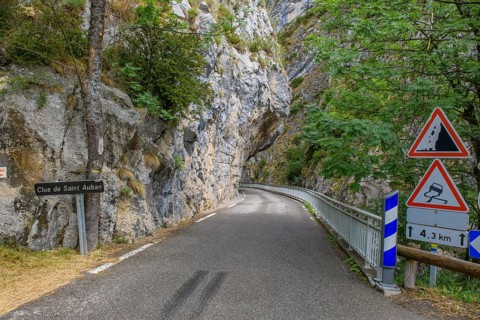 Traffic signs Warning signs at entrance of narrow road through narrow gorge Clue de St. -Auban with overhanging rock