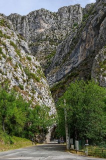 Beginning of narrow road through narrow gorge Clue de St. -Auban with overhanging rock
