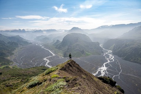 Hiker in front of mountain landscape