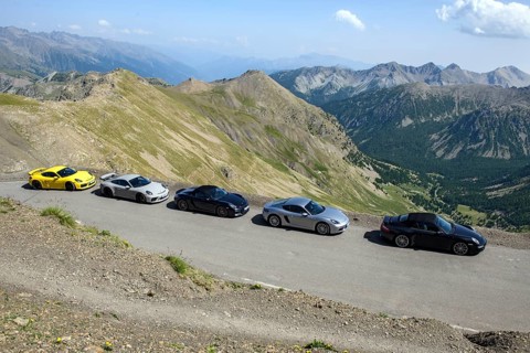 View of five Porsche sports cars on 2802 metre high highest asphalted road in Alps