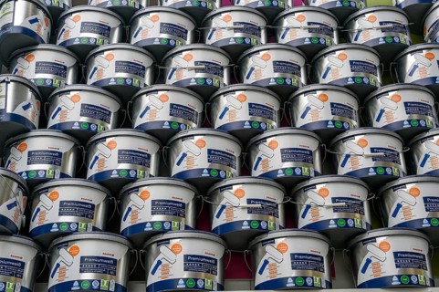 Stacked paint buckets with premium white in a DIY store