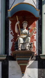 Figure with bowl and staff at the Rats-Apotheke