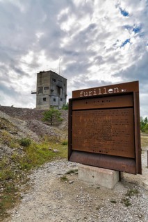 Abandoned industrial building and rusty iron welcome sign