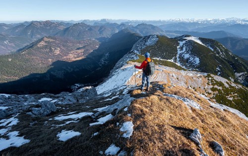 Climbers on the summit ridge with first snow in autumn