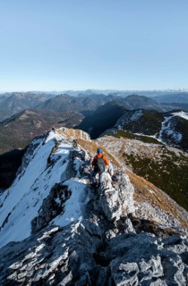 Climbers on the summit ridge with first snow in autumn