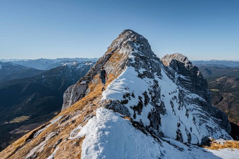 Climbers on the summit ridge with first snow in autumn