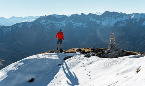 Mountaineer next to a cairn