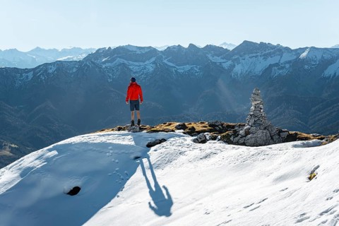 Mountaineer next to a cairn