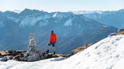 Mountaineer next to a cairn