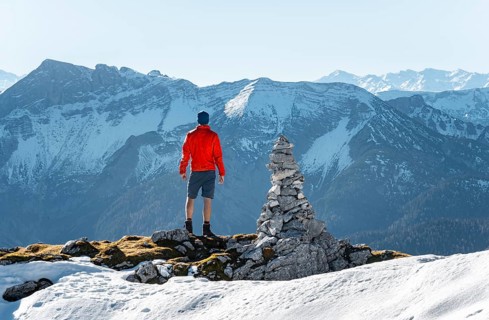 Mountaineer next to a cairn