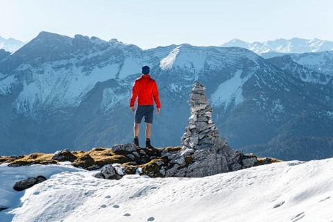 Mountaineer next to a cairn