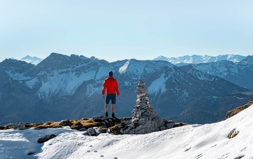 Mountaineer next to a cairn