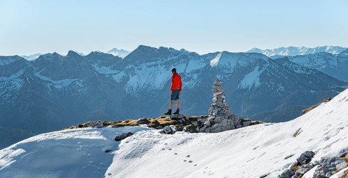 Mountaineer next to a cairn