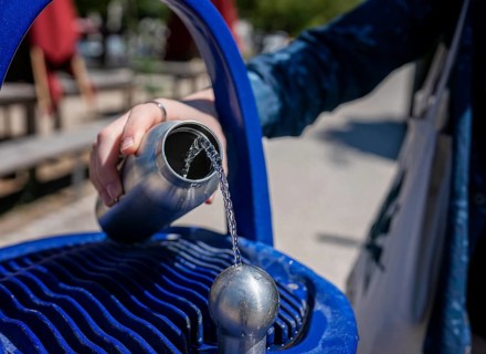Blue fountain with drinking water dispenser on a public square