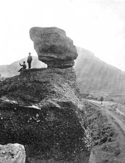 Men next to the rock formation