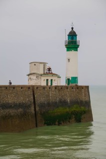 Top of the quay wall with lighthouse in the harbour of the coastal town of Le Treport at the mouth of the Bresle on the English Channel