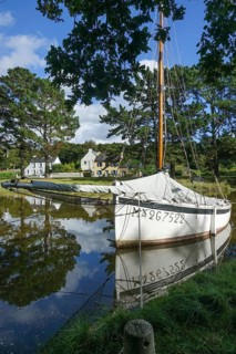 Historic sailing boat in the old harbour Pont Kalleg at the end of the inlet Anse du Moulin Neuf