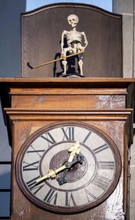Grandfather clock with rotating figure of the Death of Altoetting in the collegiate parish church of St. Philip and St. James