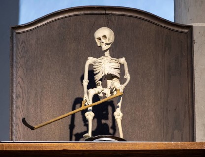 Rotating figure of the Death of Altoetting above a grandfather clock in the collegiate parish church of St. Philip and St. James