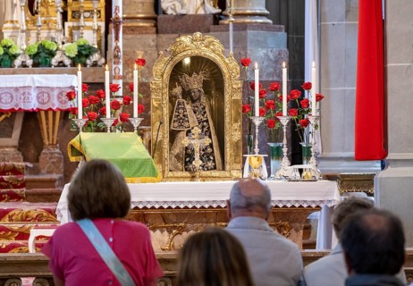 Worshippers sit in front of the Black Madonna in the collegiate parish church of St. Philip and St. James in the pilgrimage town of Altoetting. The image of grace is normally in the Holy Chapel