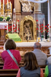 Worshippers sit in front of the Black Madonna in the collegiate parish church of St. Philip and St. James in the pilgrimage town of Altoetting. The image of grace is normally in the Holy Chapel