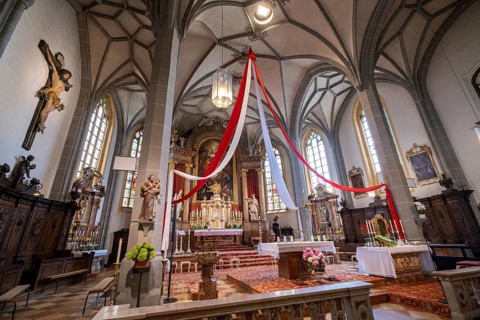 High altar of the collegiate parish church of St. Philip and St. James in the pilgrimage town of Altoetting. On the right