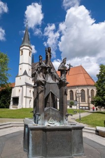 Fountain in front of the collegiate parish church of St. Philip and St. James in the pilgrimage town of Altoetting. The fountain was erected to mark the 1250th anniversary of the establishment of the ...