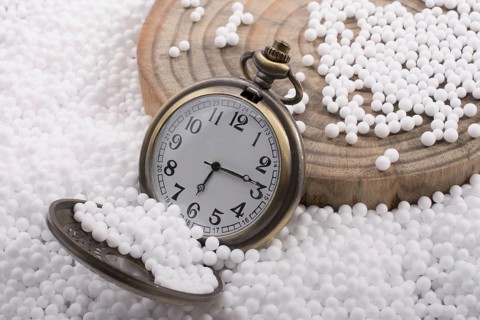 Retro pocket watch on white polystyrene balls