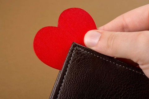 Brown leather wallet in hand saving and finance concept