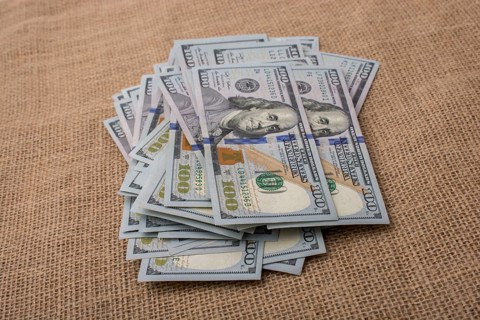 Banknote bundle of US dollar placed on a linen canvas