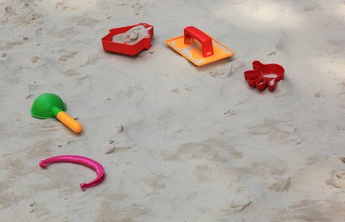 Colourful plastic children's toys in a sandbox