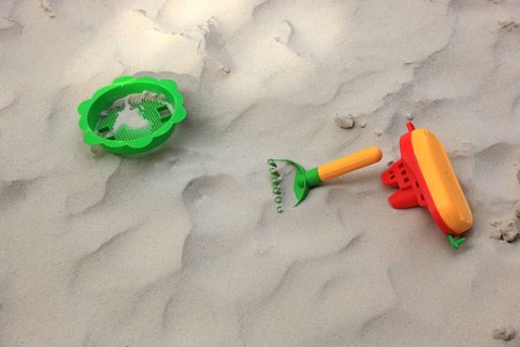 Colourful plastic children's toys in a sandbox