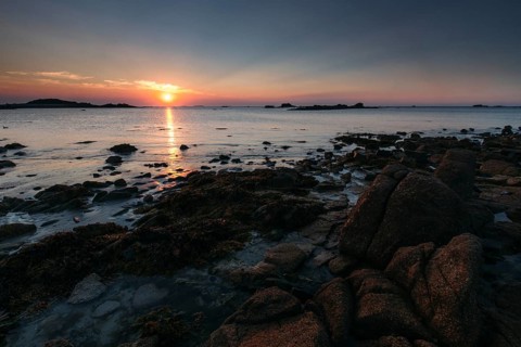 Rocks on the beach of Port Blanc in the evening light