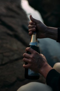 Opening a bottle of champagne on the beach