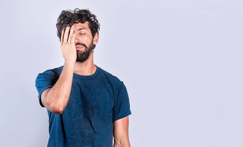 Exhausted person putting the palm of his hand on his face. Tired and exhausted man covering his face with the palm of his hand, Concept of a bored and tired man