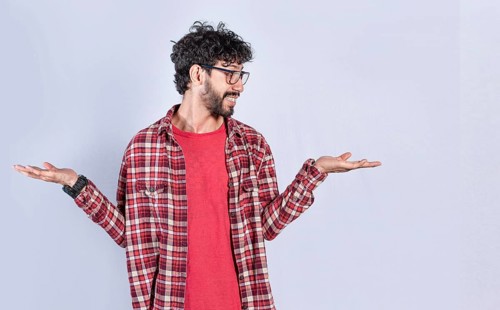 Handsome man balancing the palms of his hands, Person comparing with the palms of his hands